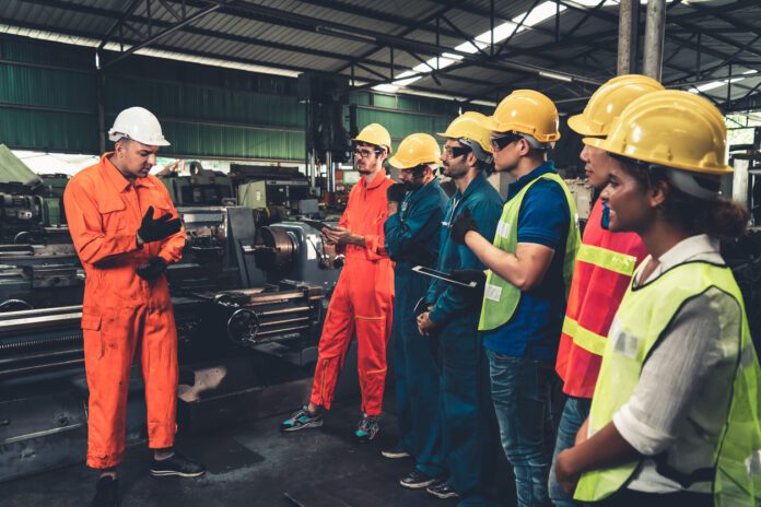 Skillful worker attending brief meeting in the factory .
